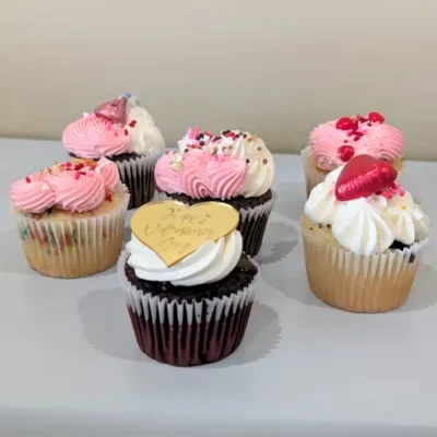 Valentine’s Gourmet Cupcake 6 Pack featuring six beautifully decorated cupcakes in flavors like Cookies n' Cream, Chocolate, Red Velvet, Funfetti, Raspberry, and Ferrero. Perfect for Valentine’s Day gifting or a sweet indulgence.